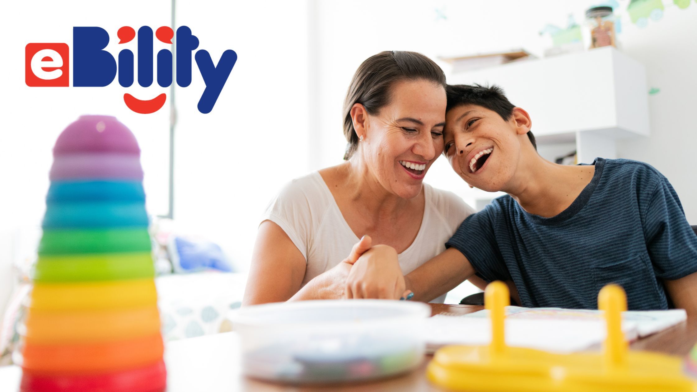 eBility. A woman and young person with cerebral palsy playing and laughing